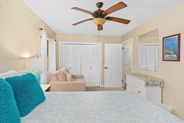 carpeted bedroom with ceiling fan and a closet