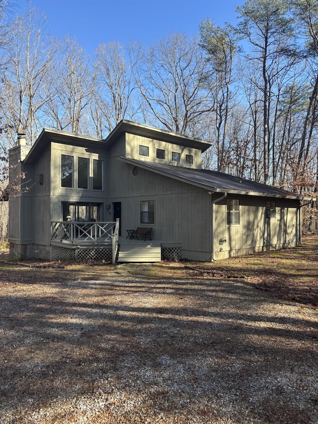 back of house featuring a wooden deck