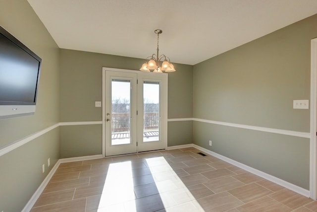 doorway to outside featuring a notable chandelier