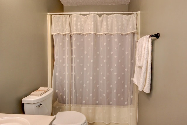 bathroom featuring vanity, toilet, and a textured ceiling