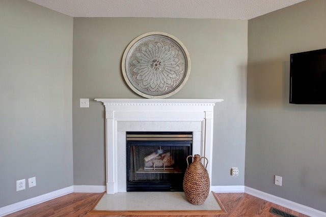 interior details with hardwood / wood-style floors and a textured ceiling