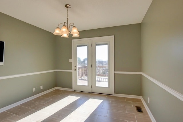 doorway featuring a notable chandelier and light tile patterned floors