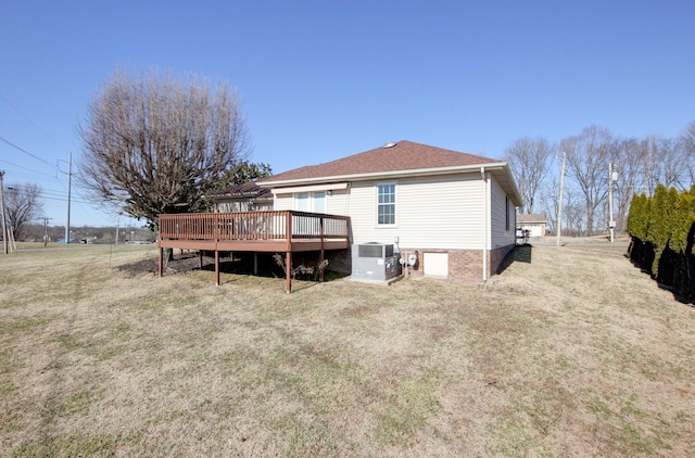 back of house with central AC unit, a yard, and a deck