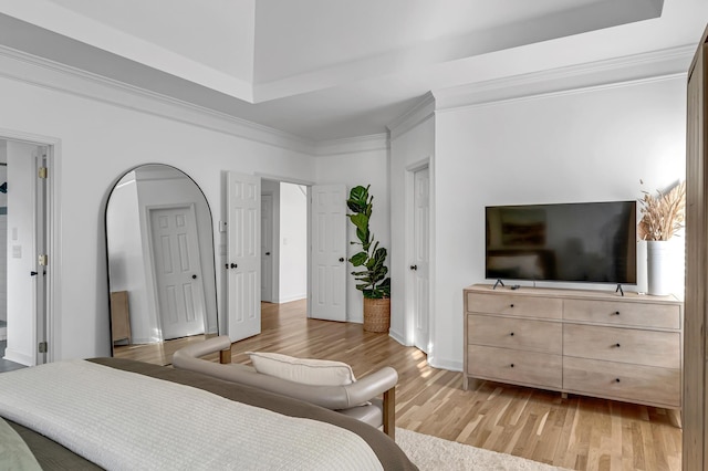 bedroom with ornamental molding and light hardwood / wood-style floors