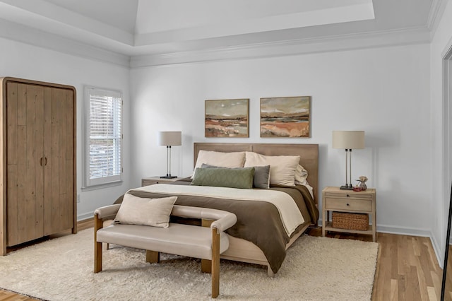 bedroom featuring light hardwood / wood-style flooring and ornamental molding