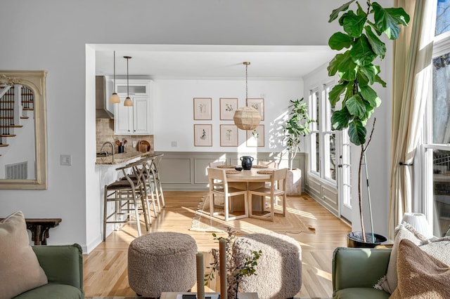 living room featuring ornamental molding and light wood-type flooring