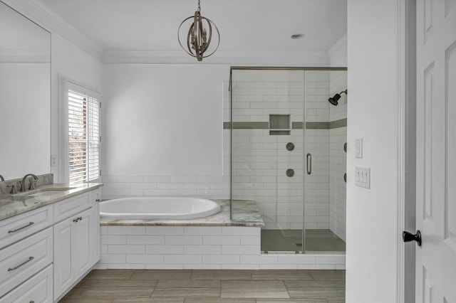 bathroom featuring vanity, crown molding, and shower with separate bathtub