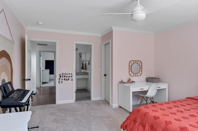 carpeted bedroom with connected bathroom, ornamental molding, and ceiling fan