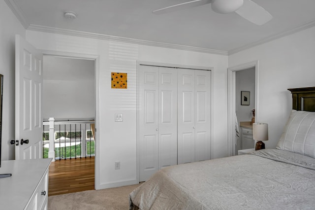 carpeted bedroom with crown molding, a closet, and ceiling fan