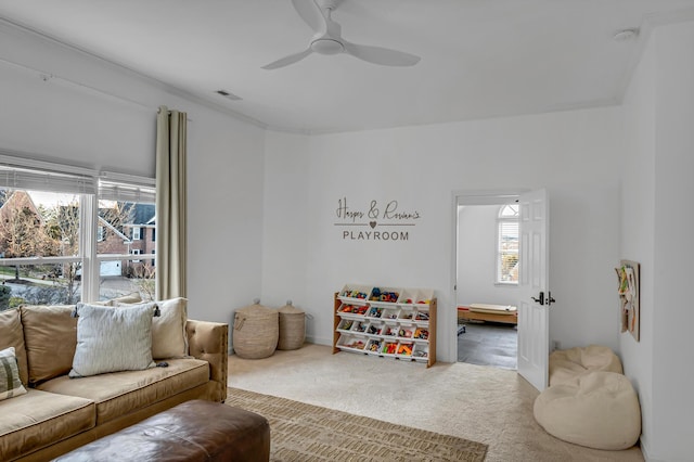 living room featuring carpet flooring and ceiling fan