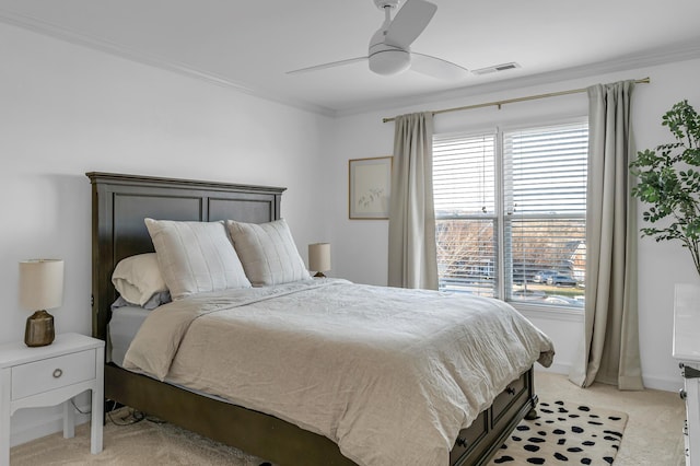 bedroom featuring ornamental molding, light carpet, and ceiling fan