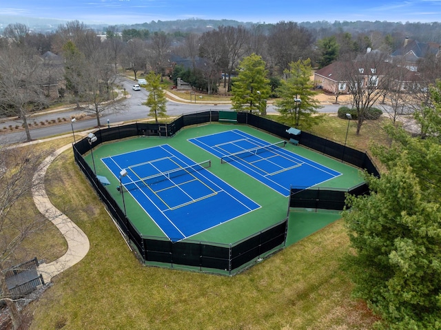 view of tennis court with a lawn