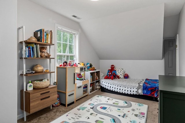 bedroom with vaulted ceiling and carpet floors