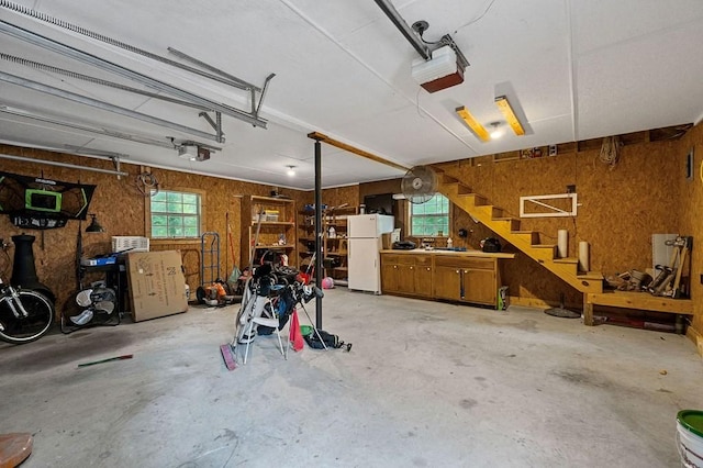 garage with white refrigerator and a garage door opener