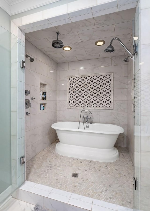 bathroom featuring plus walk in shower and tile walls