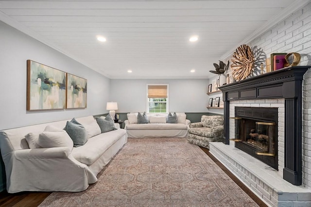 living room featuring wood ceiling, hardwood / wood-style floors, crown molding, and a fireplace