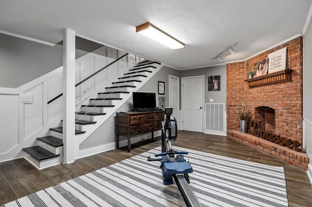 interior space with crown molding, a fireplace, and a textured ceiling