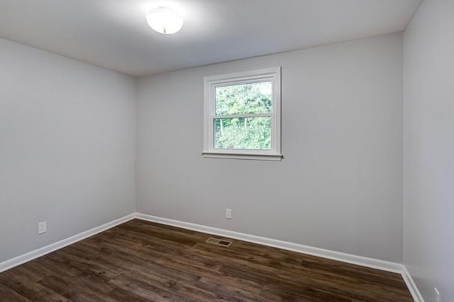 empty room featuring dark hardwood / wood-style flooring