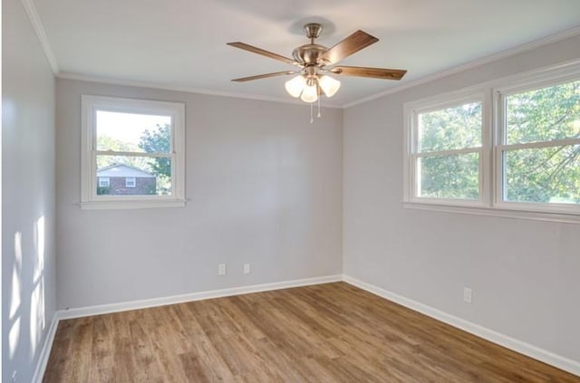 empty room with ornamental molding, hardwood / wood-style floors, and ceiling fan