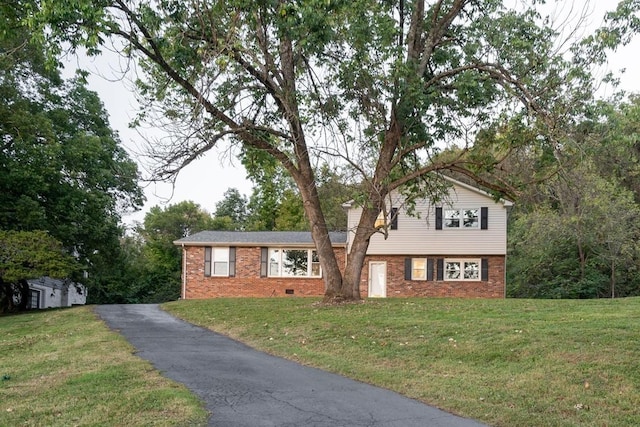 tri-level home with a front yard