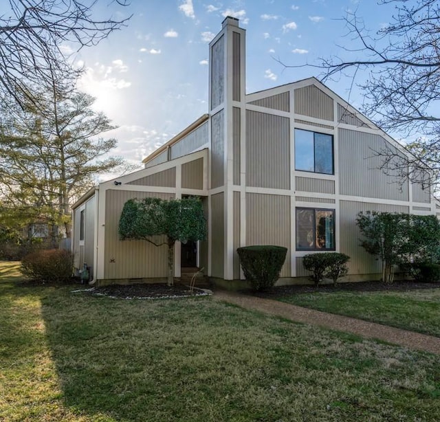 view of side of home with a yard