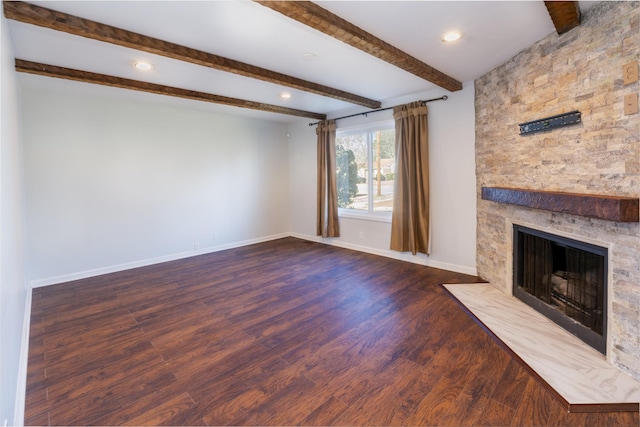 unfurnished living room featuring wood-type flooring, a large fireplace, and beamed ceiling