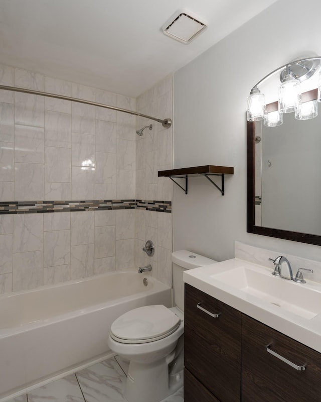 full bathroom with tiled shower / bath combo, vanity, and toilet