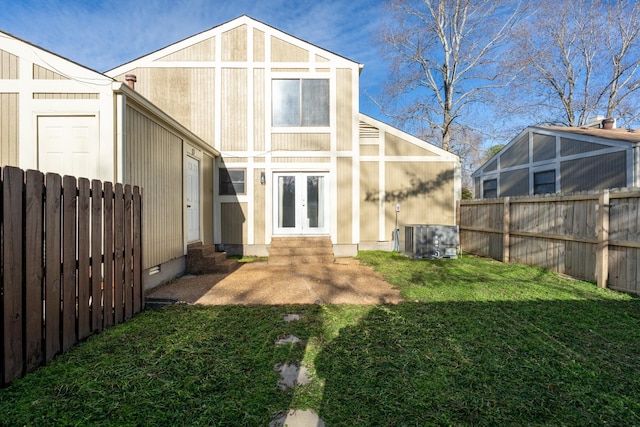 back of house with a yard, french doors, and central air condition unit