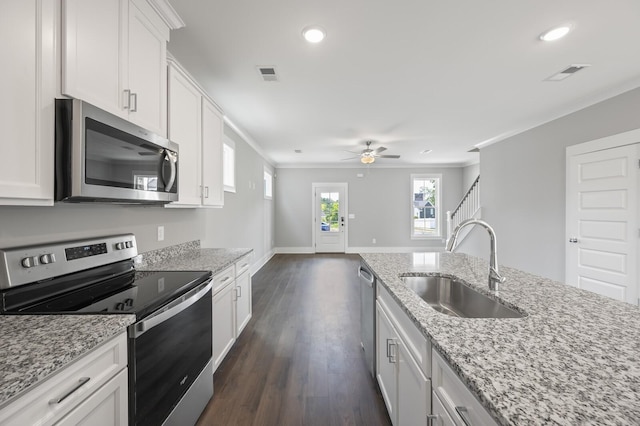 kitchen with white cabinetry, sink, stainless steel appliances, and light stone countertops