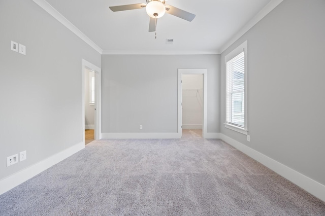 carpeted spare room with ornamental molding and ceiling fan