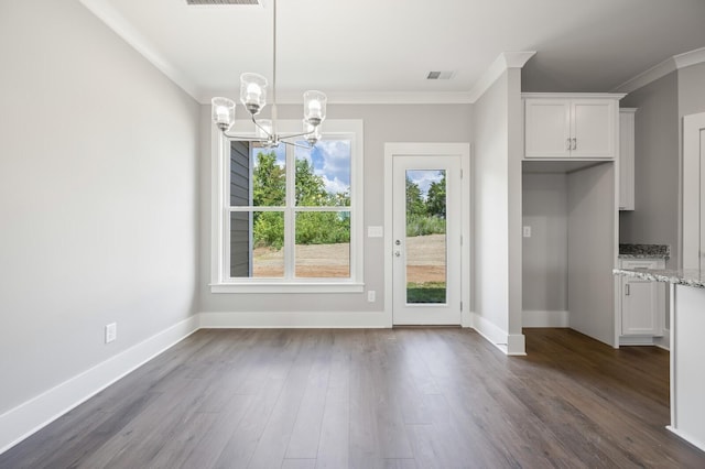 unfurnished dining area with ornamental molding, dark wood-type flooring, and a notable chandelier