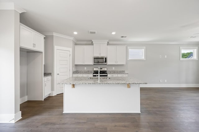 kitchen featuring light stone countertops, appliances with stainless steel finishes, a center island with sink, and white cabinets