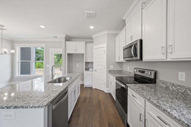 kitchen featuring white cabinetry, dark wood-type flooring, a center island with sink, and appliances with stainless steel finishes