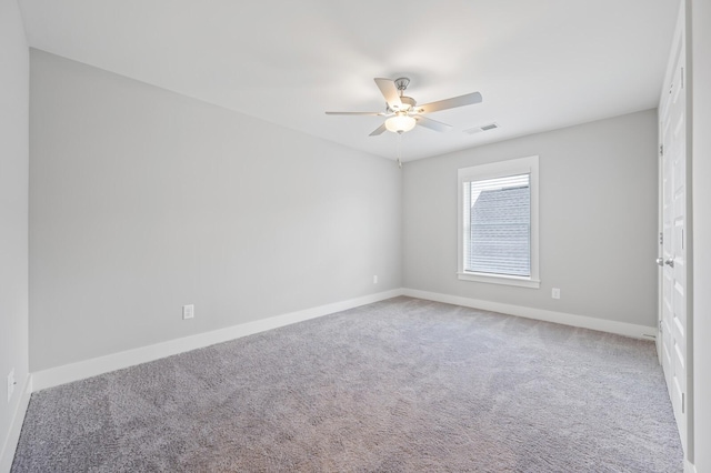 carpeted spare room featuring ceiling fan