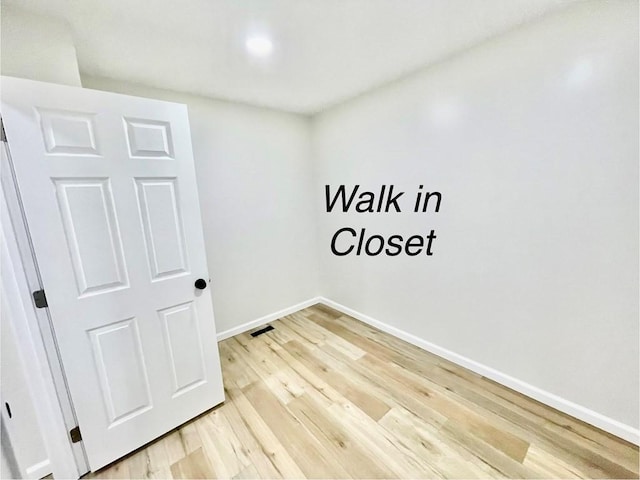 unfurnished room featuring hardwood / wood-style flooring