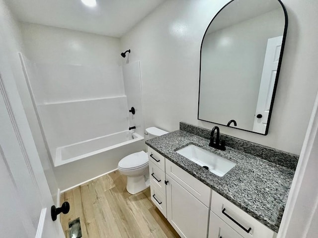 full bathroom with vanity, hardwood / wood-style flooring, shower / tub combination, and toilet