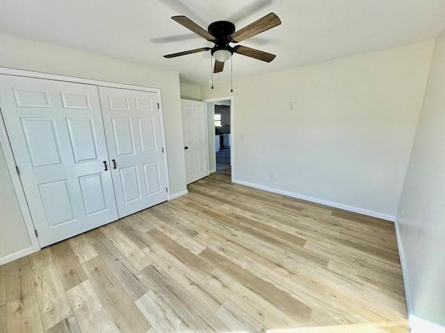 unfurnished bedroom featuring a closet, ceiling fan, and light wood-type flooring