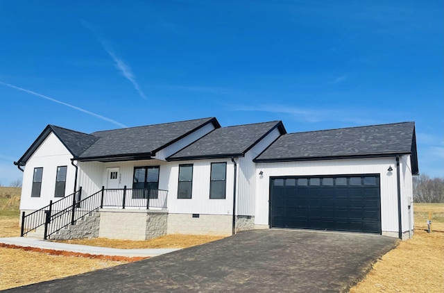 modern farmhouse featuring a garage and a porch