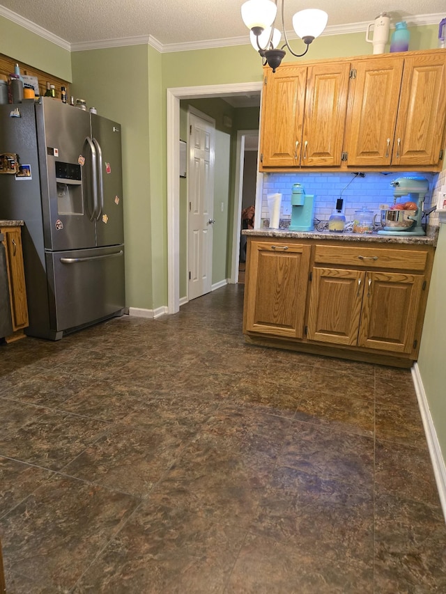 kitchen with stainless steel refrigerator with ice dispenser, a textured ceiling, backsplash, and crown molding