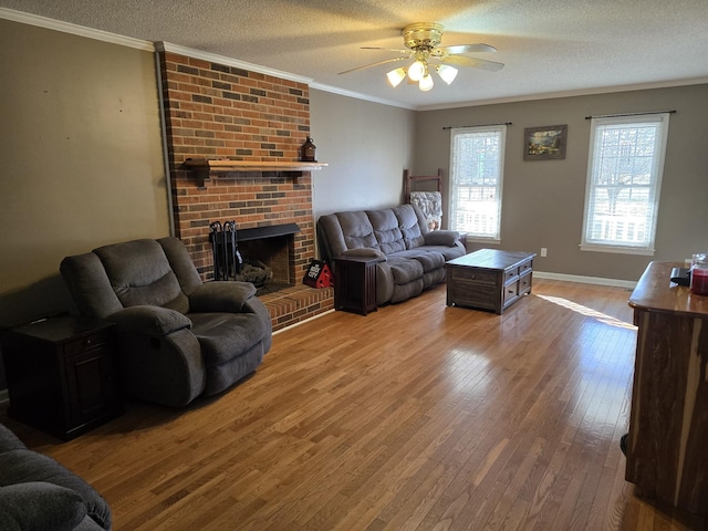 living room featuring hardwood / wood-style flooring, ornamental molding, and a textured ceiling