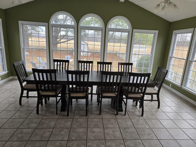 tiled dining area featuring ceiling fan, lofted ceiling, and a wealth of natural light