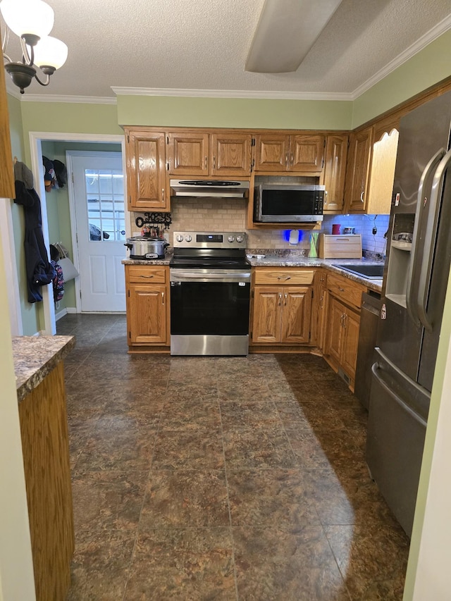 kitchen with tasteful backsplash, crown molding, appliances with stainless steel finishes, and a textured ceiling