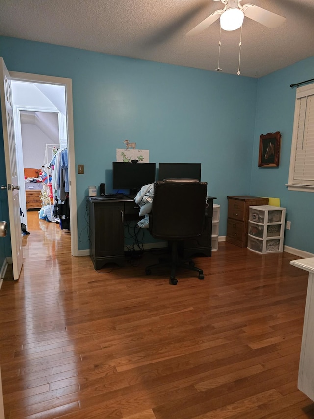 office featuring ceiling fan, wood-type flooring, and a textured ceiling