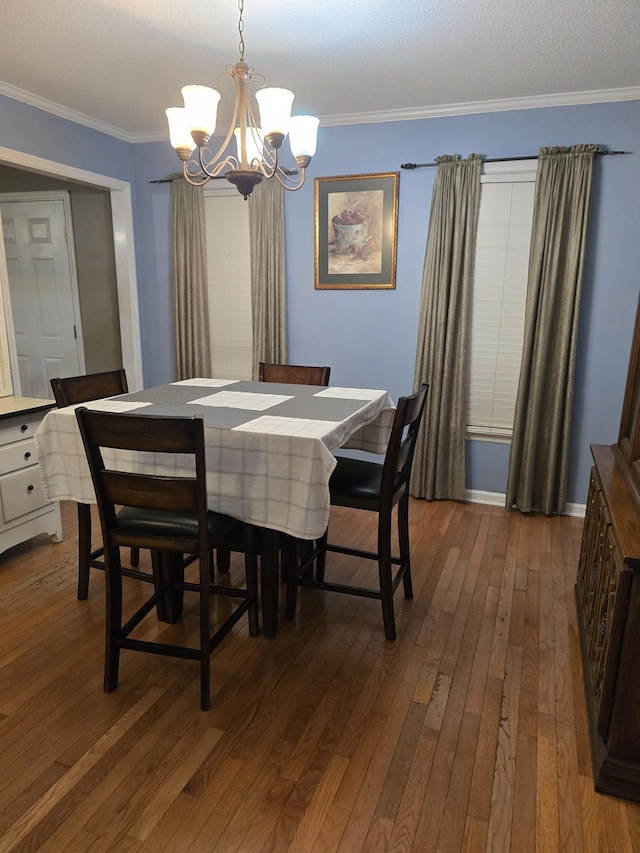 dining room featuring a notable chandelier, crown molding, and dark wood-type flooring