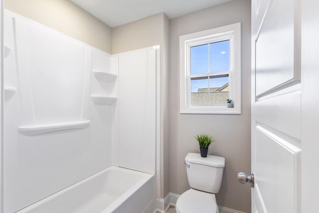 bathroom featuring bathtub / shower combination and toilet