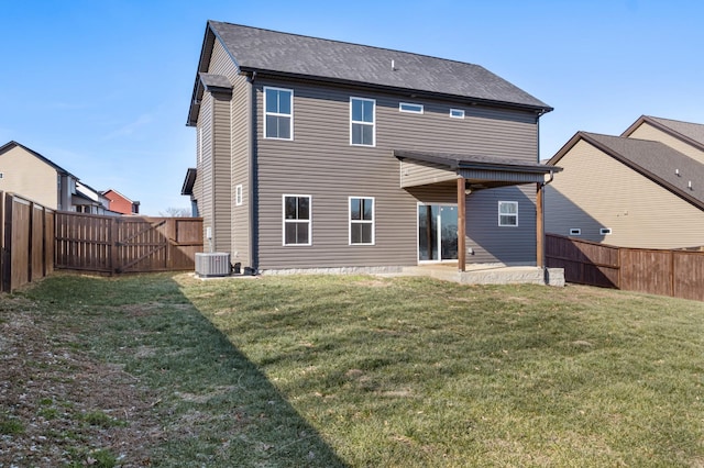 rear view of house with central AC unit, a patio area, and a lawn