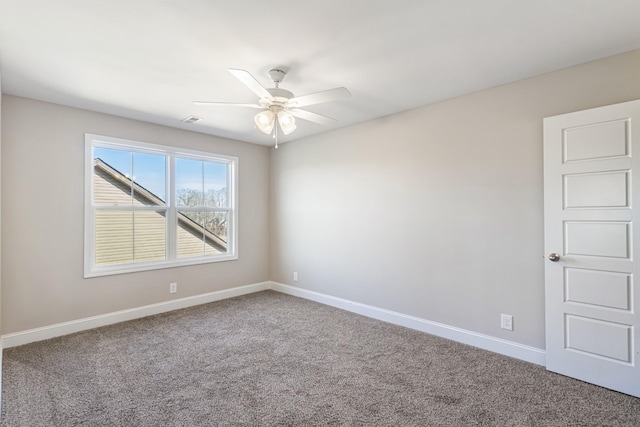 carpeted spare room featuring ceiling fan