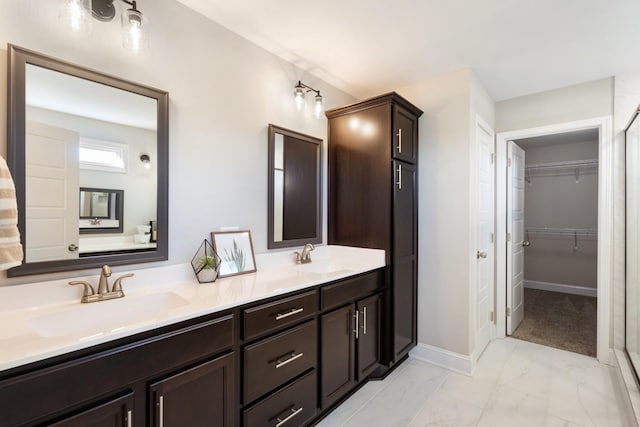 bathroom featuring vanity and a shower with door