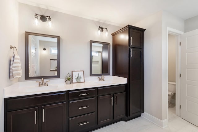 bathroom with vanity, toilet, and tile patterned flooring