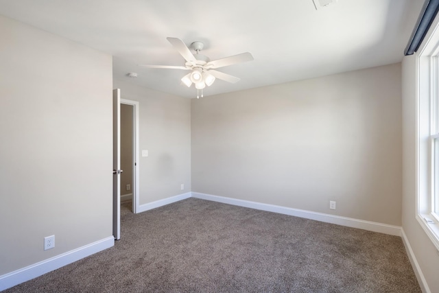 empty room with ceiling fan and carpet